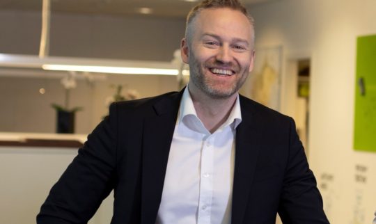 A smiling Jan Erik Gausdal, Sales Director at Eye-share AS in office surroundings