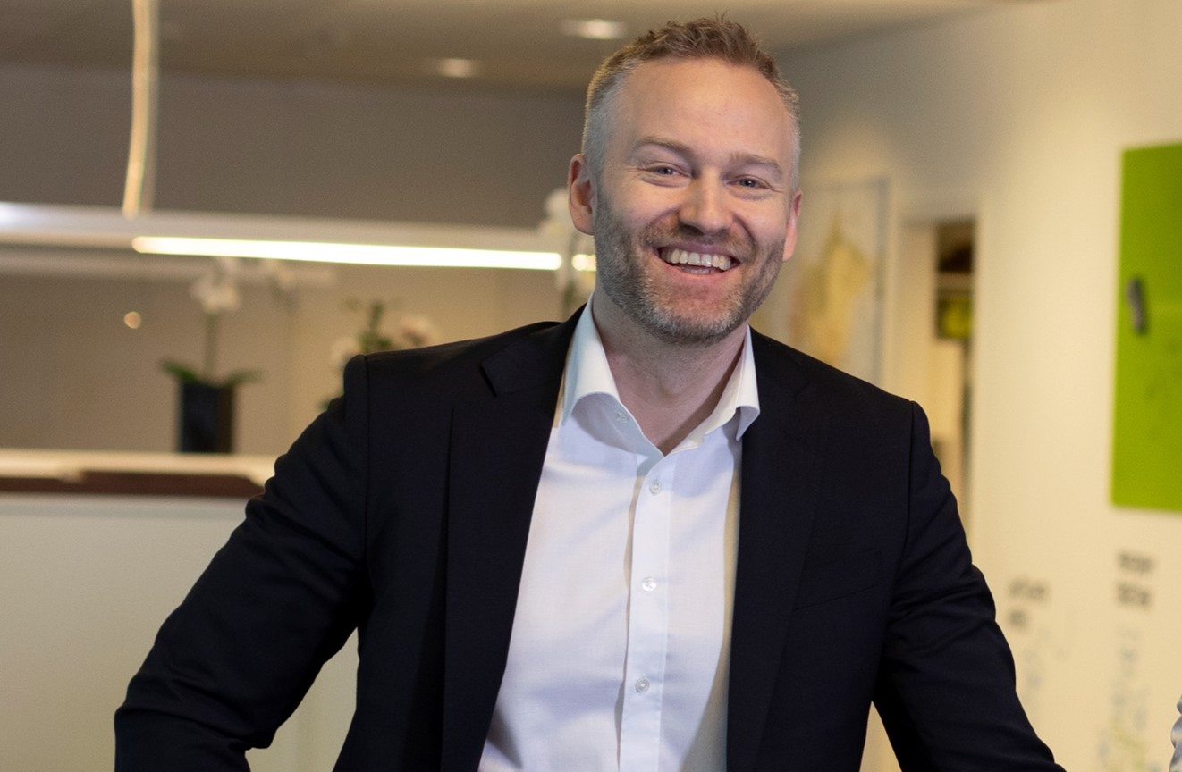 A smiling Jan Erik Gausdal, Sales Director at Eye-share AS in office surroundings