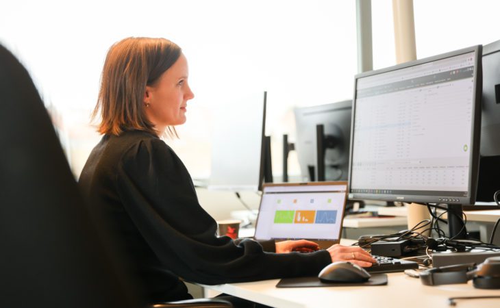 Product Manager Eva Michaelsen sitting infront of a computer.