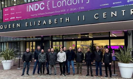Showing the Eye-share software developer team in front of the conference arena at NDC London 2024