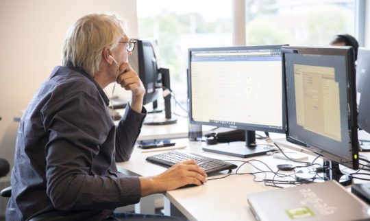 Man with earphones working on his computer