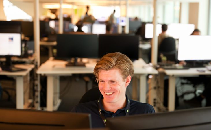 William Skaar, Technical Consultant in front of computer smiling.