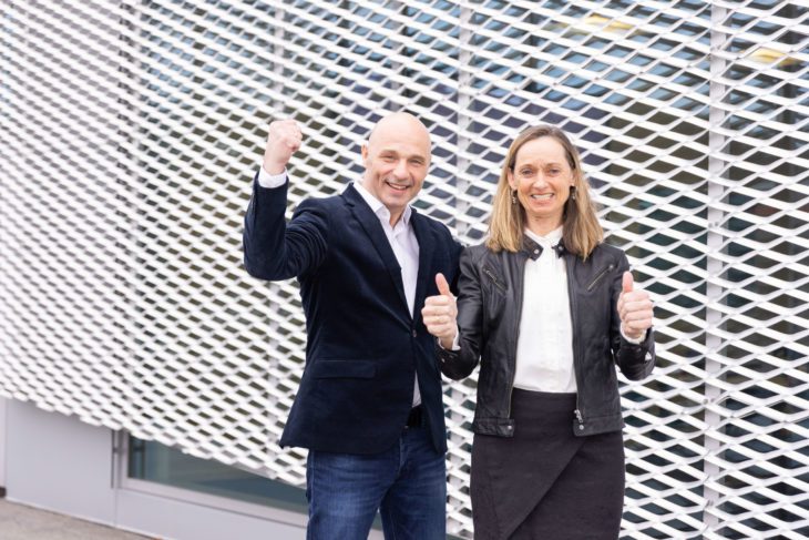 Director of Partners and International offices and CEO Torhill Falnes cheering outside an office building.