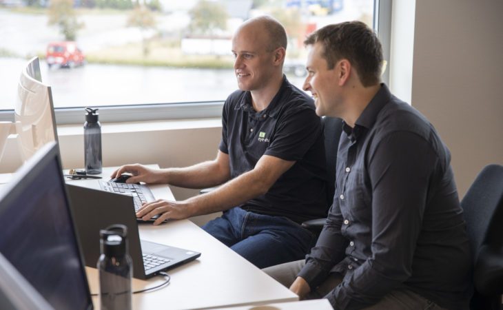 Eye-share employees working in front of computer in office premises smiling